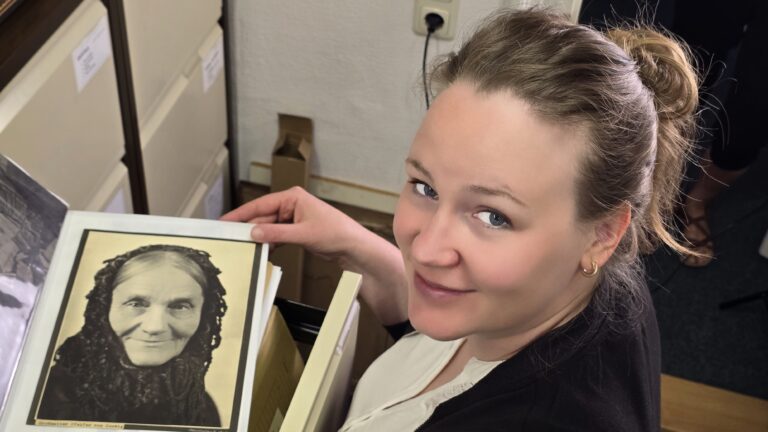 Museumspädagogin Annabell Rink mit dem Erhardt-Foto "Großmutter Pfeifer aus Coswig". Foto © Branczeisz