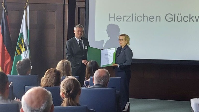 Bürgermeister Siegfried Zenker nimmt die Urkunde von Barbara Klepsch entgegen. Foto © Weinböhla
